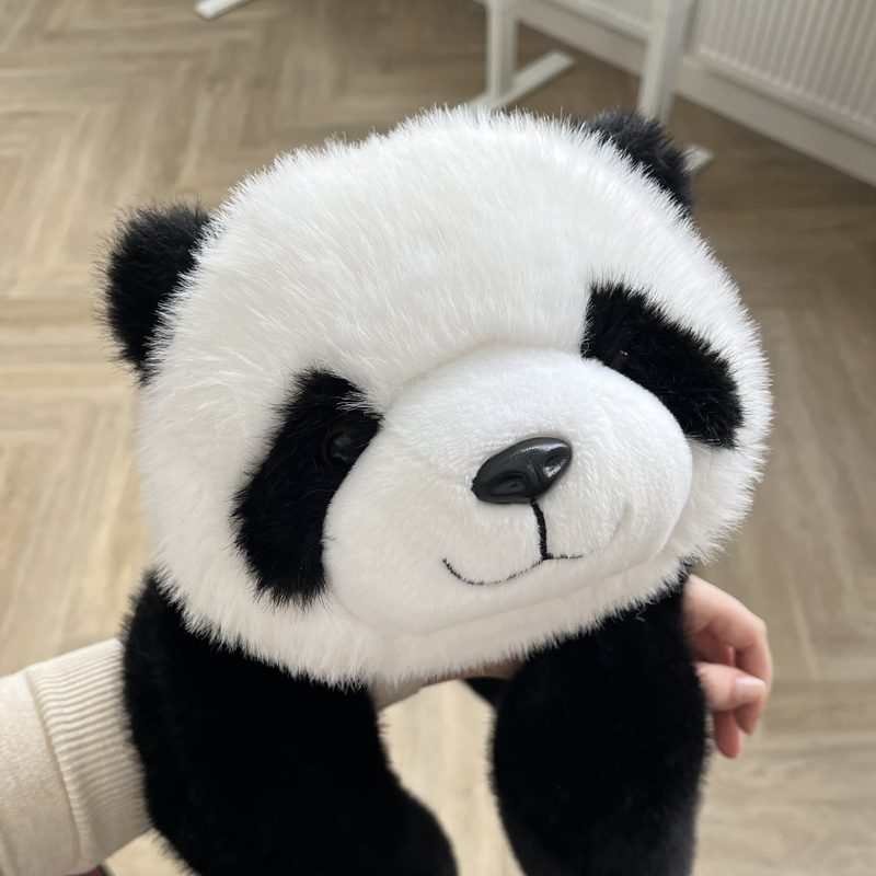Pookie the Panda held up with its long weighted arms hanging down